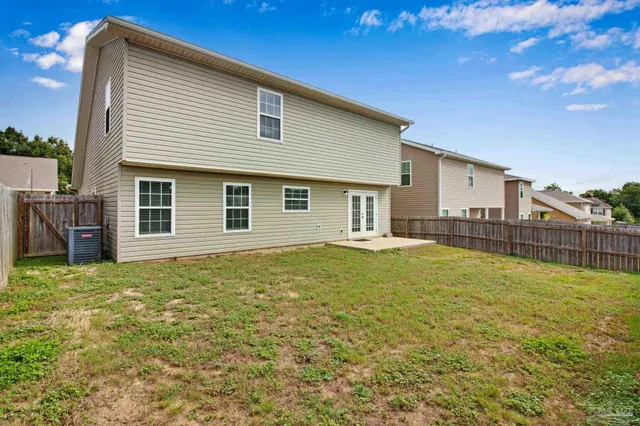 a house view with swimming pool in front of it