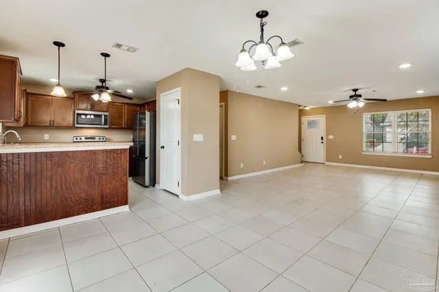 a open kitchen with cabinets and stainless steel appliances