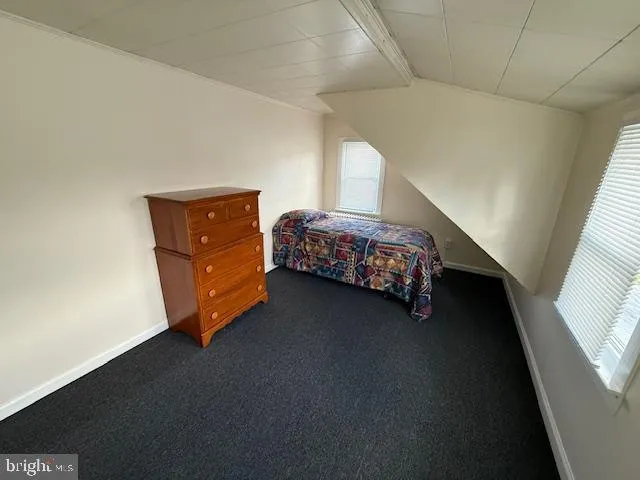 a bedroom with a bed lamp and a window