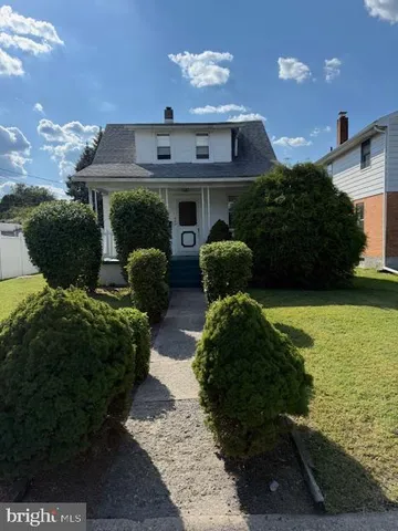 a view of a house with a yard and potted plants