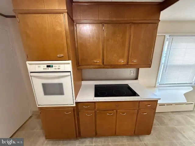 a kitchen with a cabinets and white stove top oven