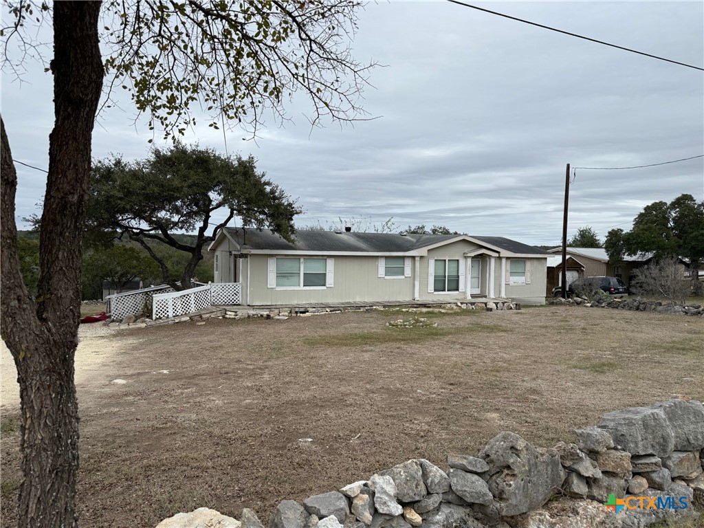 10080 Rebecca Creek Road Spring Branch, TX 78070 - Photo 3 of 16 a view of a yard in front of a house with large tree