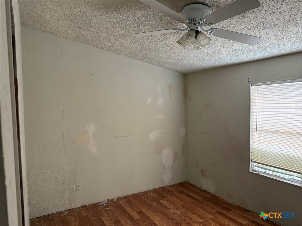10080 Rebecca Creek Road Spring Branch, TX 78070 - Photo 10 of 16 a view of a hallway with a window and a ceiling fan