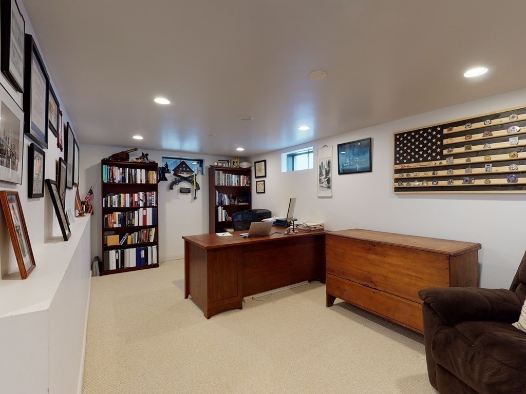 26 Grosvenor Road Waltham, MA 02453 - Photo 20 of 35 a living room with lots of furniture and a book shelf