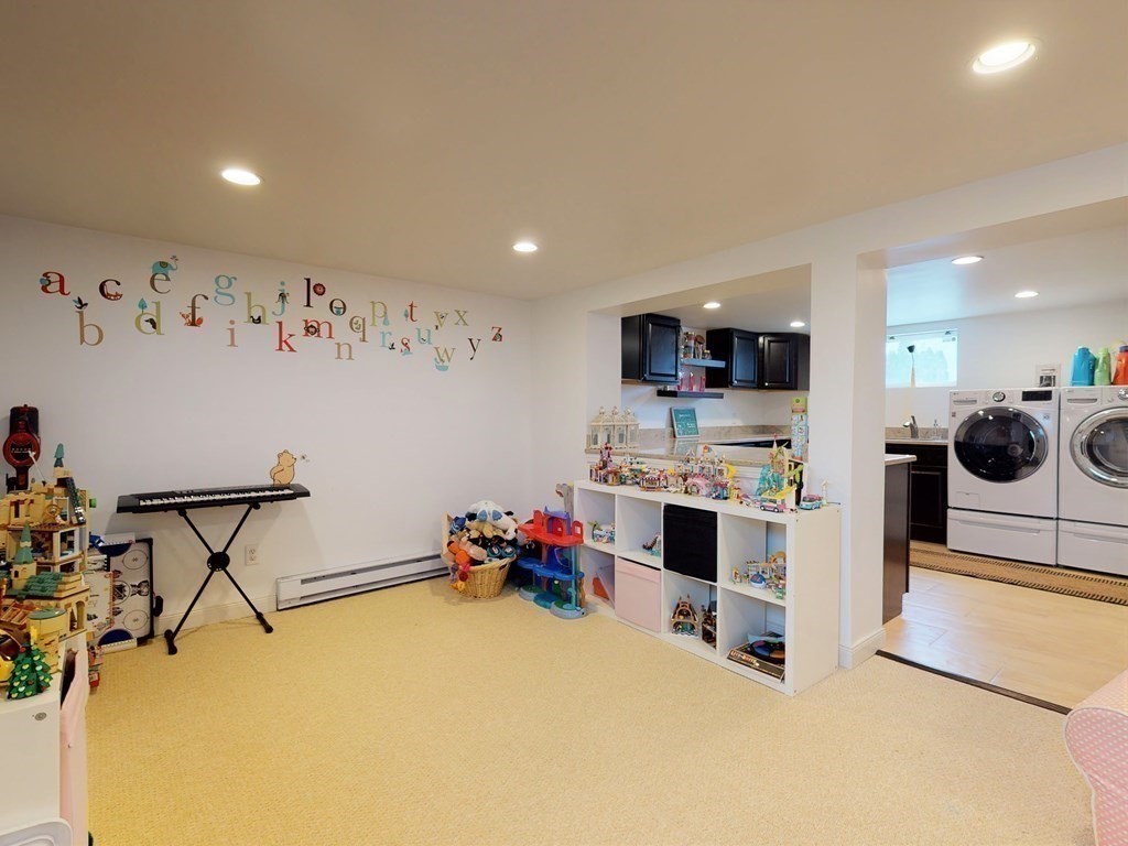 26 Grosvenor Road Waltham, MA 02453 - Photo 22 of 35 a view of a kitchen with kitchen island white cabinets and wooden floor