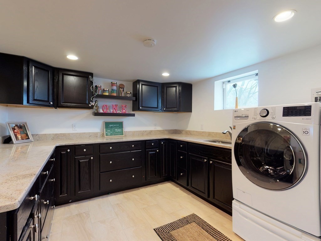 26 Grosvenor Road Waltham, MA 02453 - Photo 23 of 35 a kitchen with a sink and a stove top oven with wooden floor