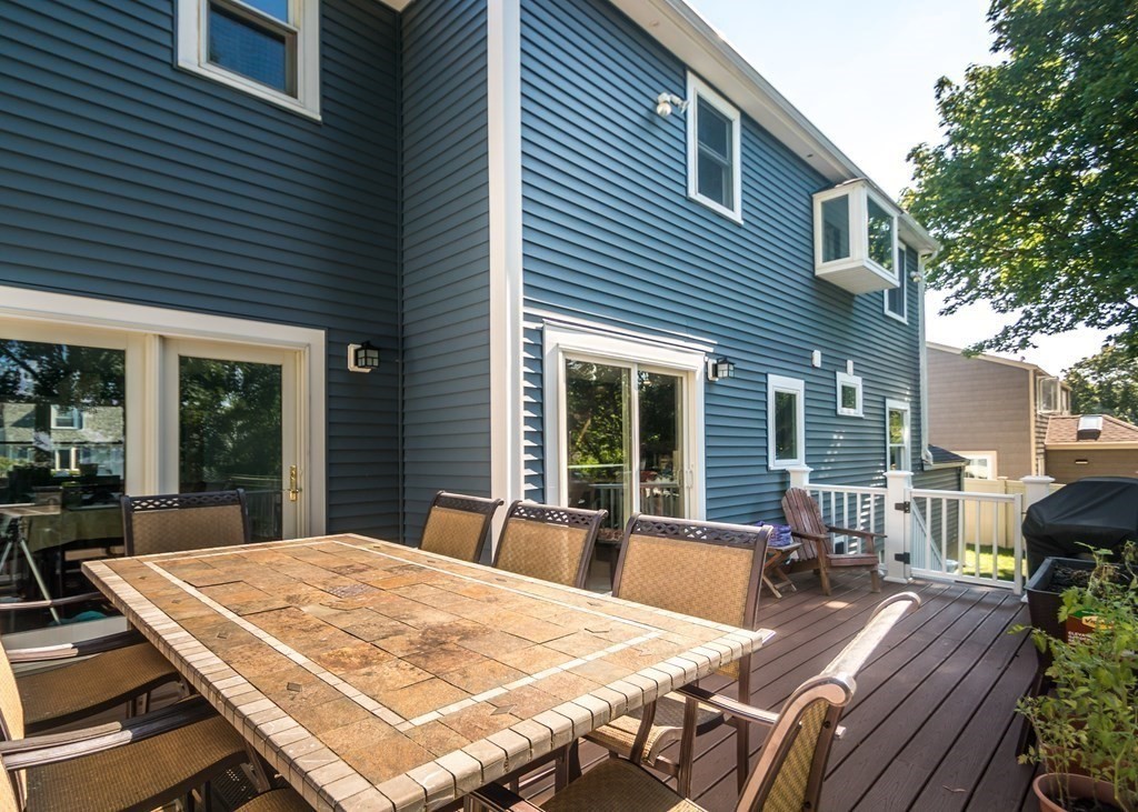 26 Grosvenor Road Waltham, MA 02453 - Photo 30 of 35 a view of a patio with table and chairs and wooden fence
