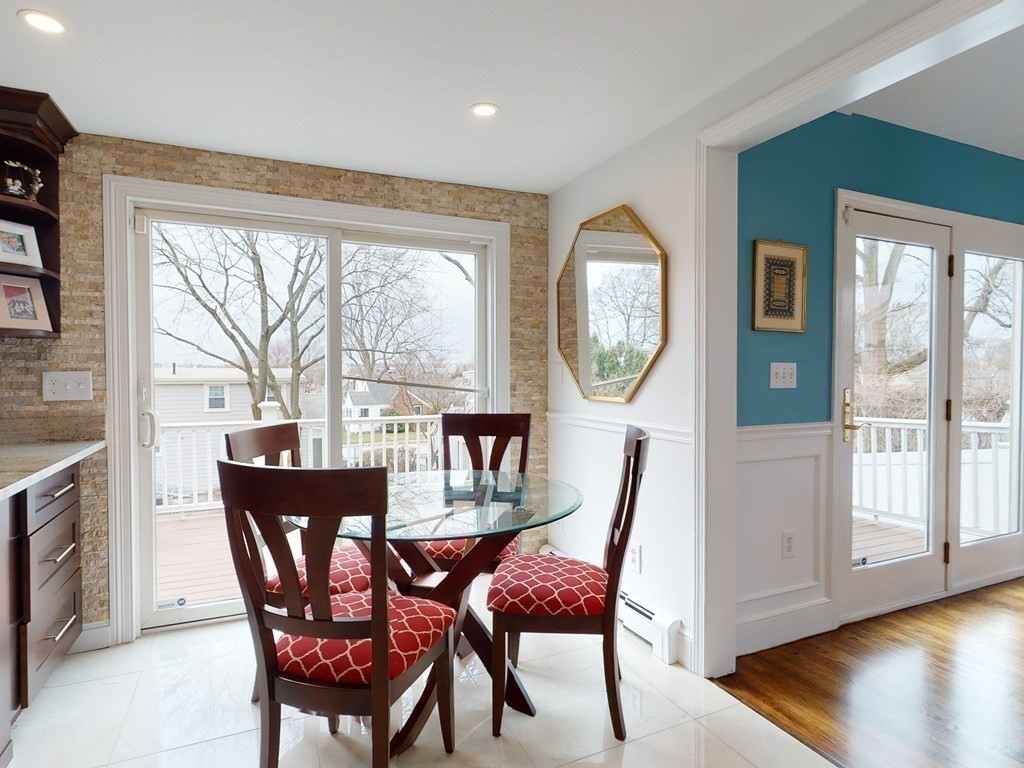 26 Grosvenor Road Waltham, MA 02453 - Photo 7 of 35 a dining room with furniture a rug and a large window