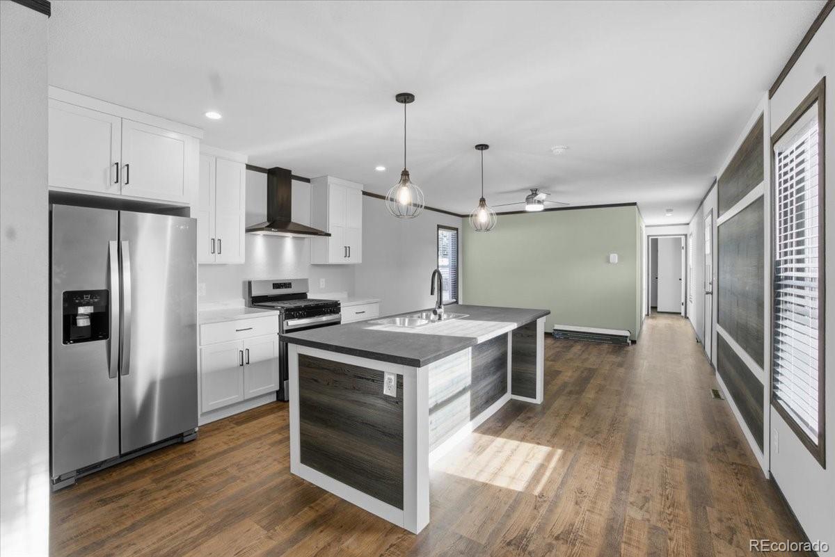 230 North 2nd Berthoud, CO 80513 - Photo 13 of 21 a kitchen with a stove a refrigerator and a sink