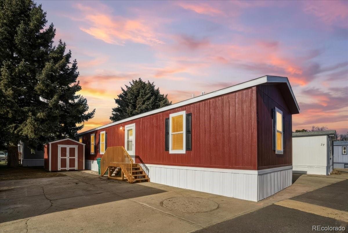 230 North 2nd Berthoud, CO 80513 - Photo 21 of 21 a view of a house with many windows and a tree