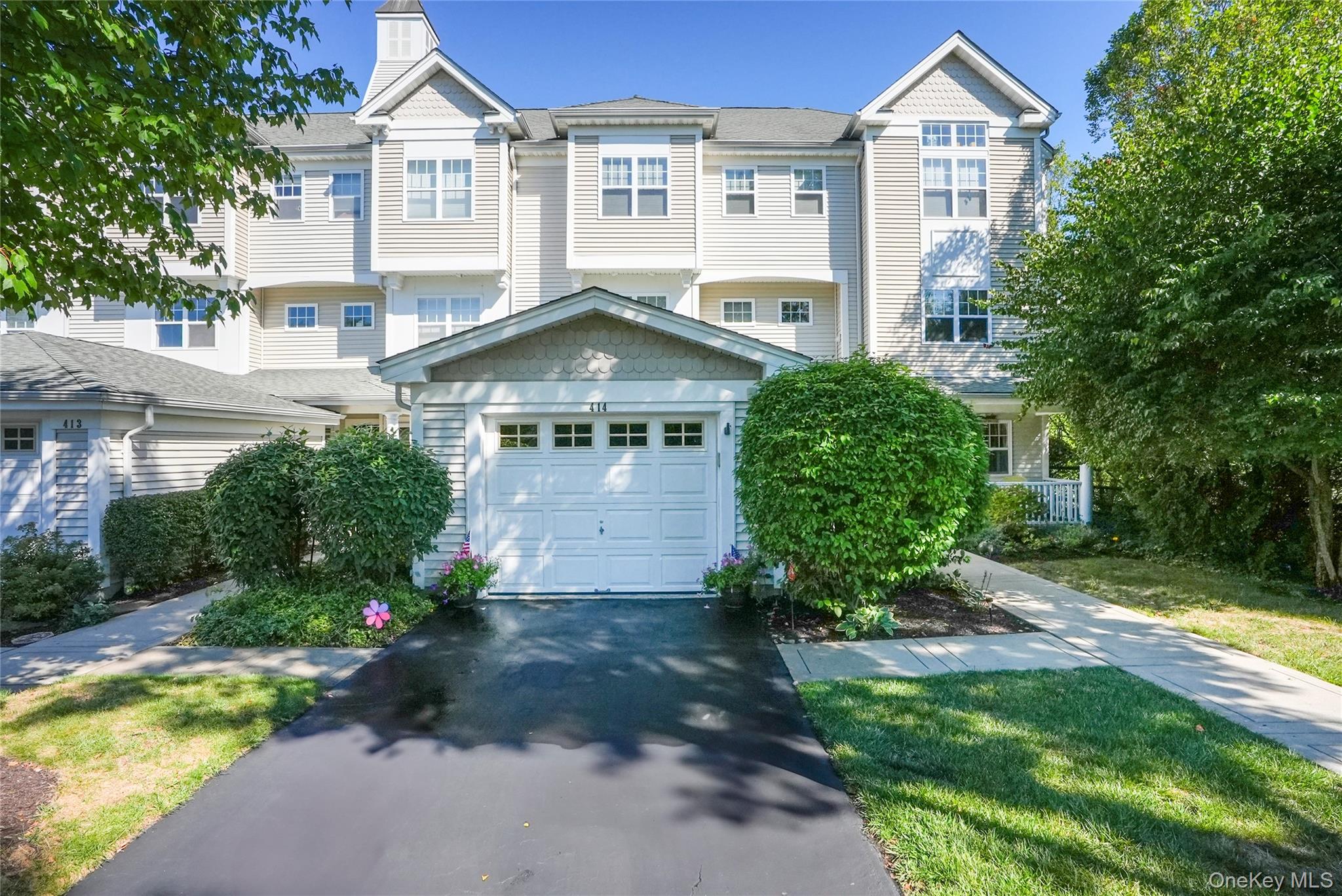 View of front facade featuring asphalt driveway and a residential view