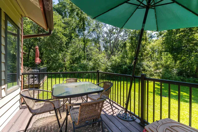 a view of a chairs and table in the balcony
