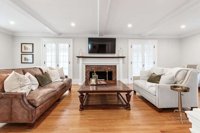6 Hayes Avenue Lexington, MA 02420 - Photo 14 of 34 a living room with furniture and a fireplace