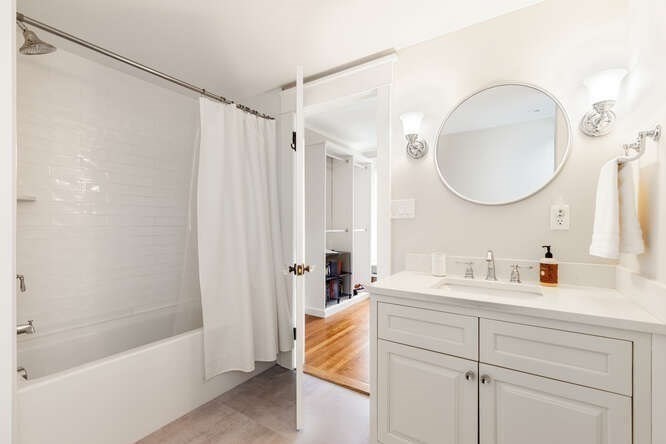 6 Hayes Avenue Lexington, MA 02420 - Photo 25 of 34 a en suite bathroom with a double vanity sink a mirror and a bathtub