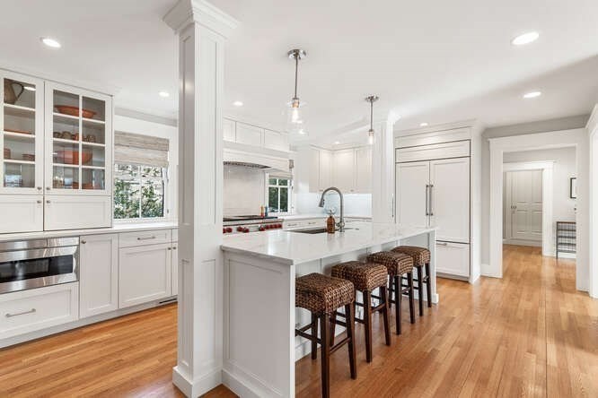 6 Hayes Avenue Lexington, MA 02420 - Photo 8 of 34 a kitchen with stainless steel appliances a dining table chairs stove and cabinets