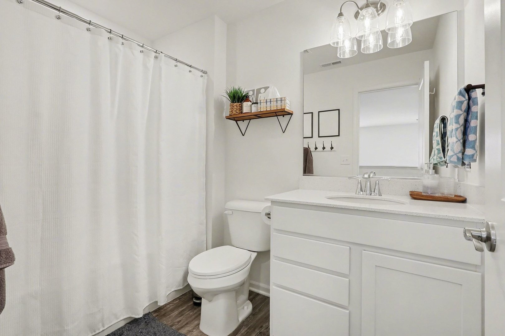 24754 McCormick Way Manhattan, IL 60442 - Photo 12 of 15 a bathroom with a sink a toilet and shower curtain