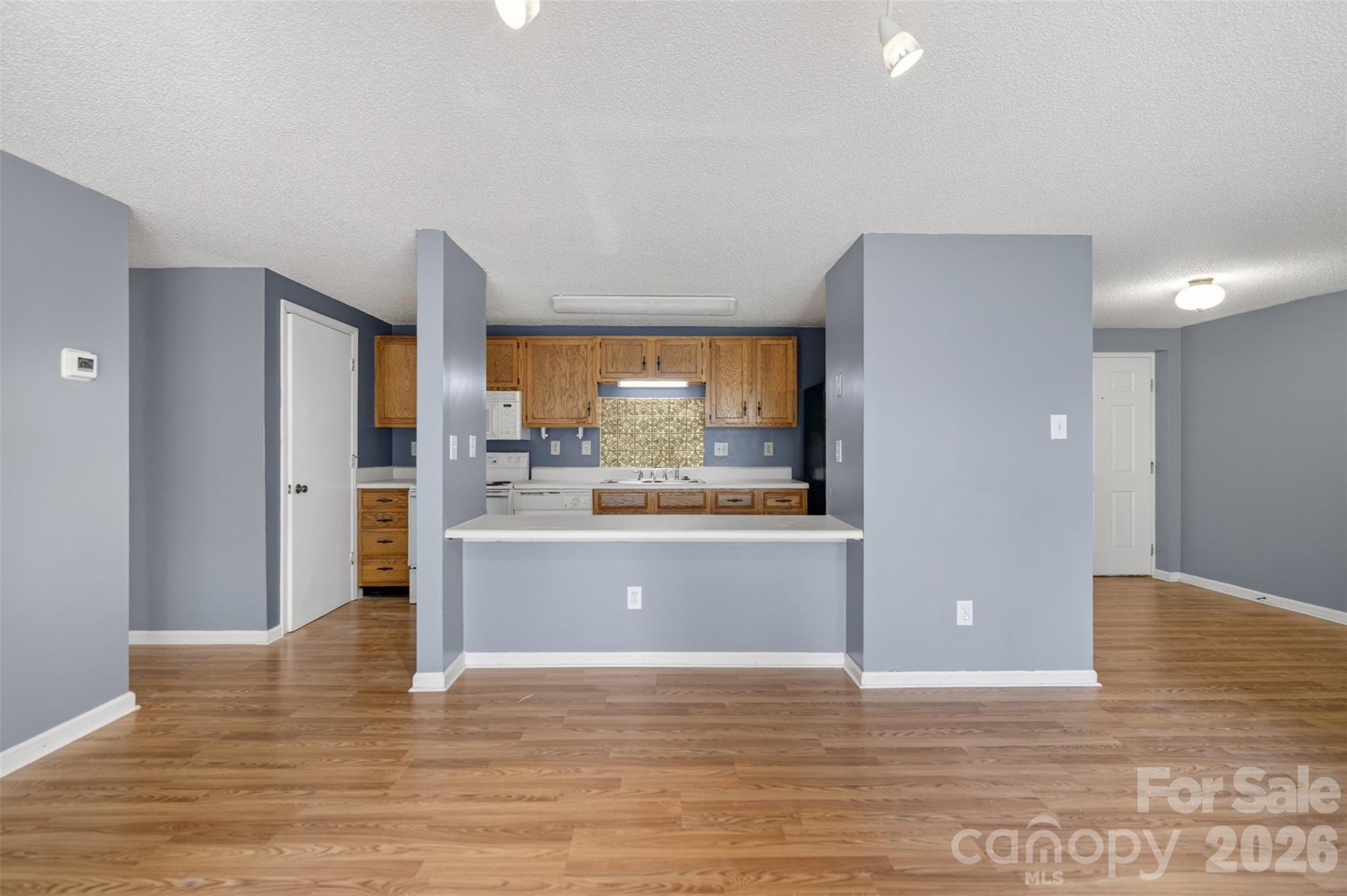 9405 Old Concord Road, Unit C Charlotte, NC 28213 - Photo 9 of 27 a view of a kitchen with wooden floor and a large window