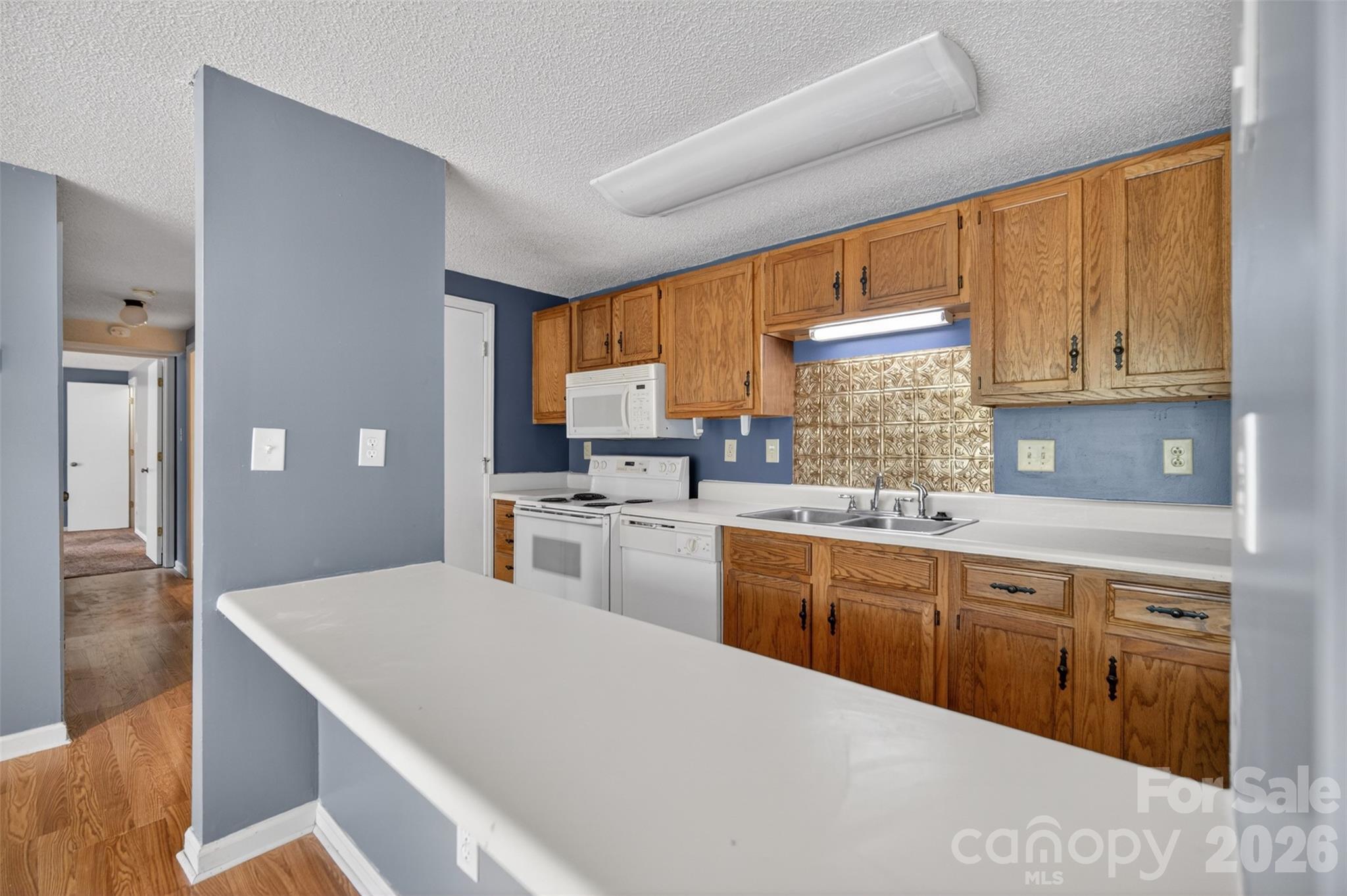 9405 Old Concord Road, Unit C Charlotte, NC 28213 - Photo 10 of 27 a kitchen with granite countertop a sink stainless steel appliances and cabinets