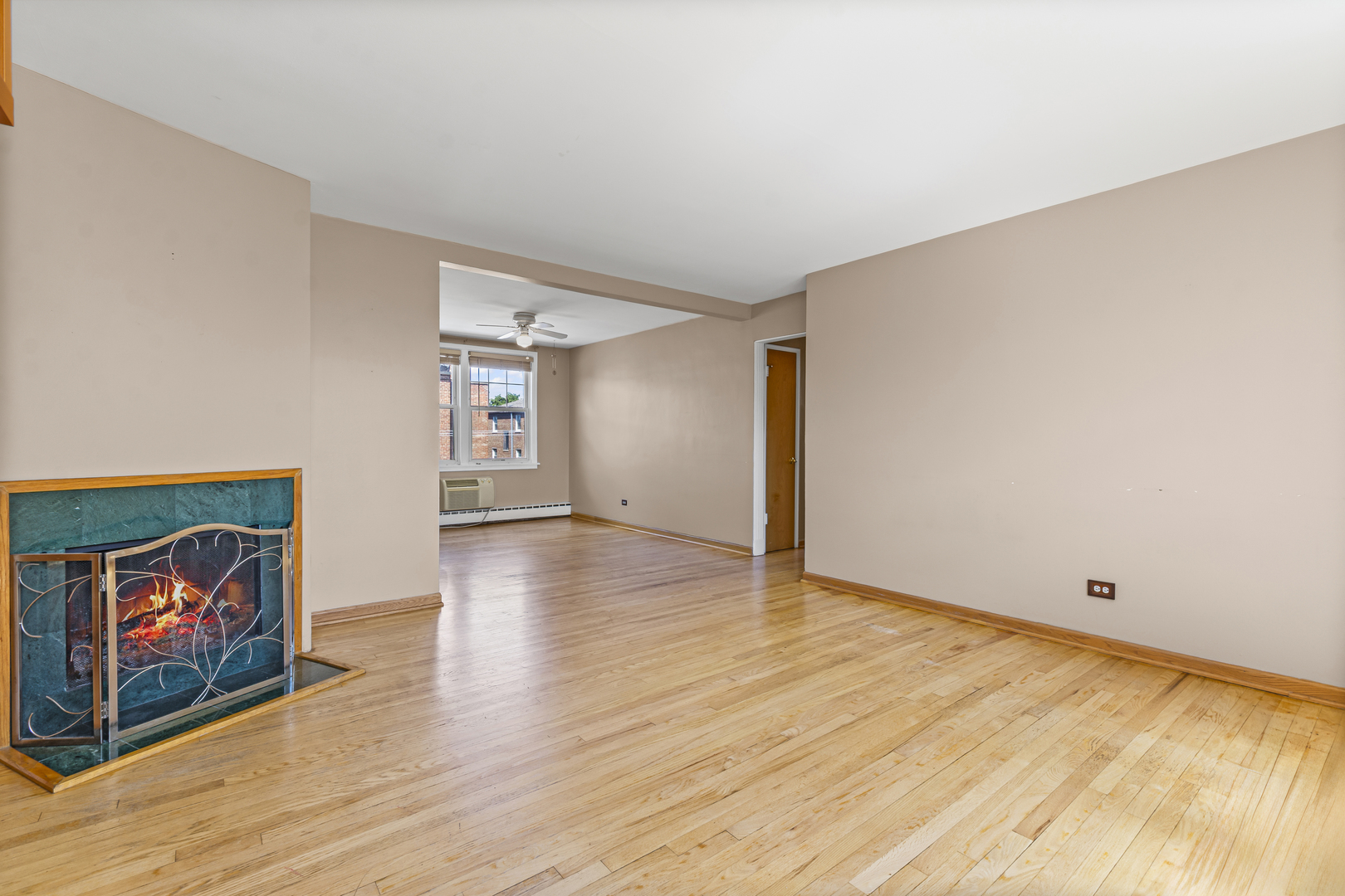 2434 West Farragut Avenue, Unit 3B Chicago, IL 60625 - Photo 11 of 20 an empty room with wooden floor and painting on the wall