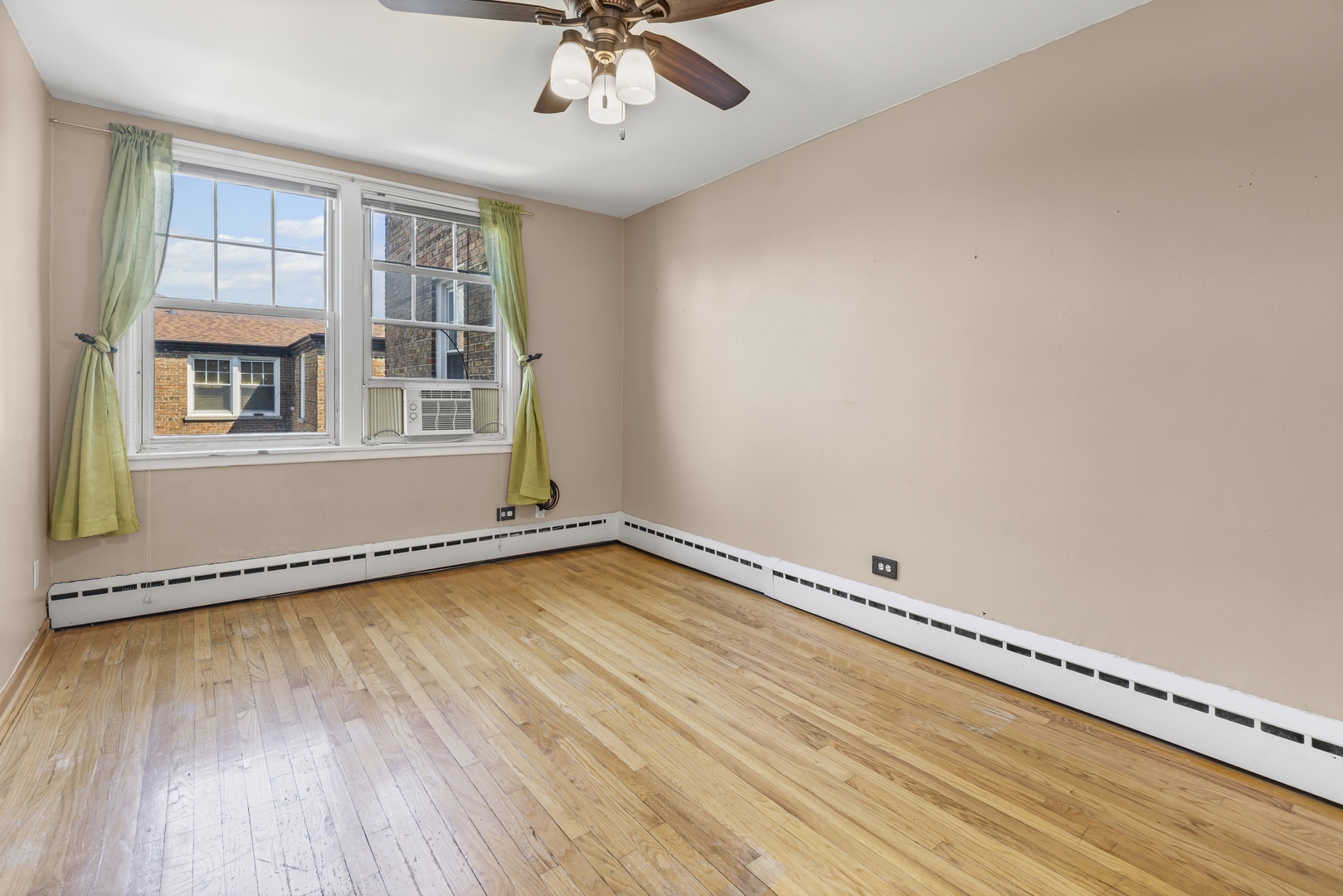 2434 West Farragut Avenue, Unit 3B Chicago, IL 60625 - Photo 14 of 20 wooden floor in an empty room with a window