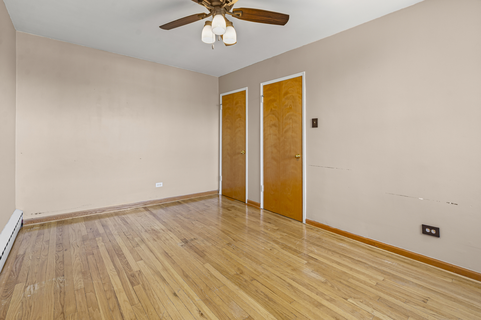 2434 West Farragut Avenue, Unit 3B Chicago, IL 60625 - Photo 15 of 20 an empty room with wooden floor and windows