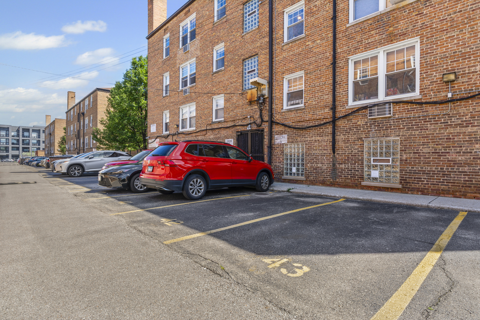 2434 West Farragut Avenue, Unit 3B Chicago, IL 60625 - Photo 18 of 20 a cars parked in front of brick building