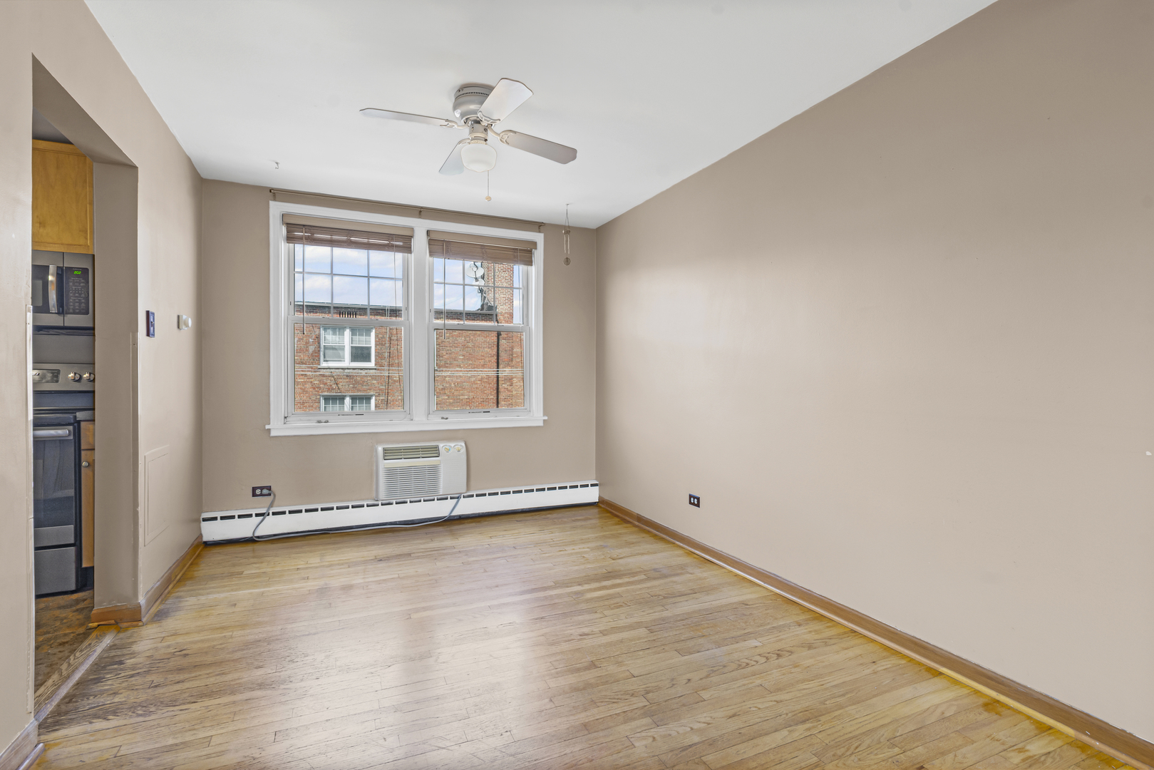 2434 West Farragut Avenue, Unit 3B Chicago, IL 60625 - Photo 2 of 20 wooden floor in an empty room with a window