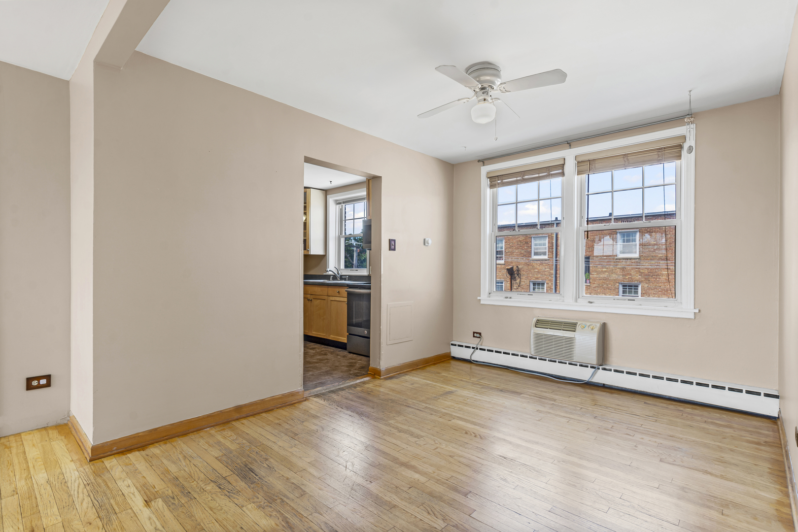 2434 West Farragut Avenue, Unit 3B Chicago, IL 60625 - Photo 3 of 20 an empty room with wooden floor and windows