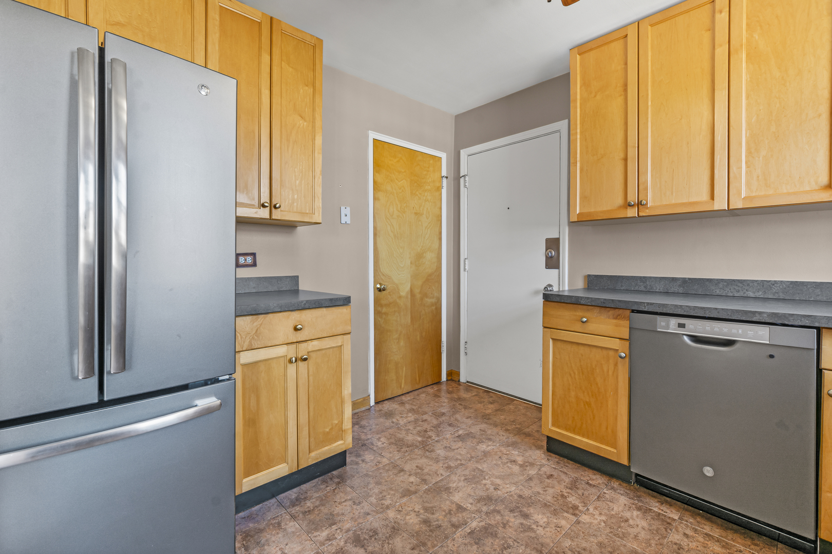 2434 West Farragut Avenue, Unit 3B Chicago, IL 60625 - Photo 8 of 20 a kitchen with stainless steel appliances granite countertop a refrigerator and a stove