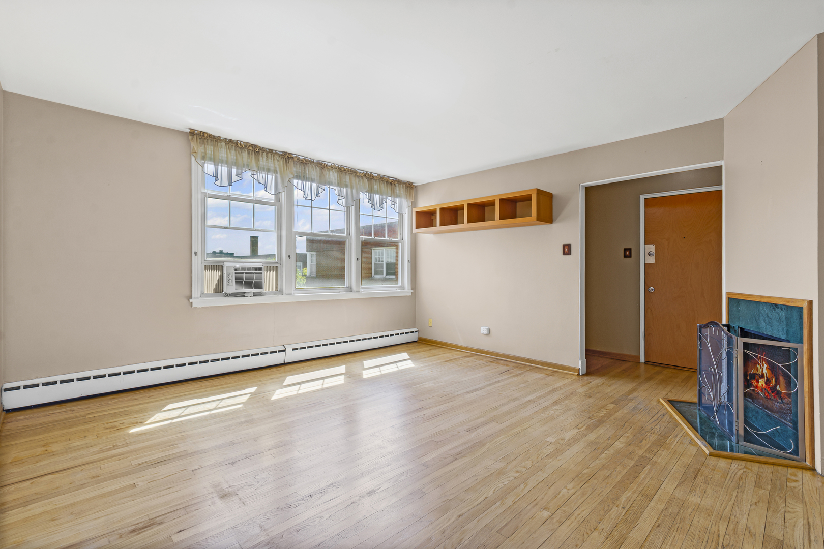 2434 West Farragut Avenue, Unit 3B Chicago, IL 60625 - Photo 9 of 20 a view of an empty room with wooden floor and a window