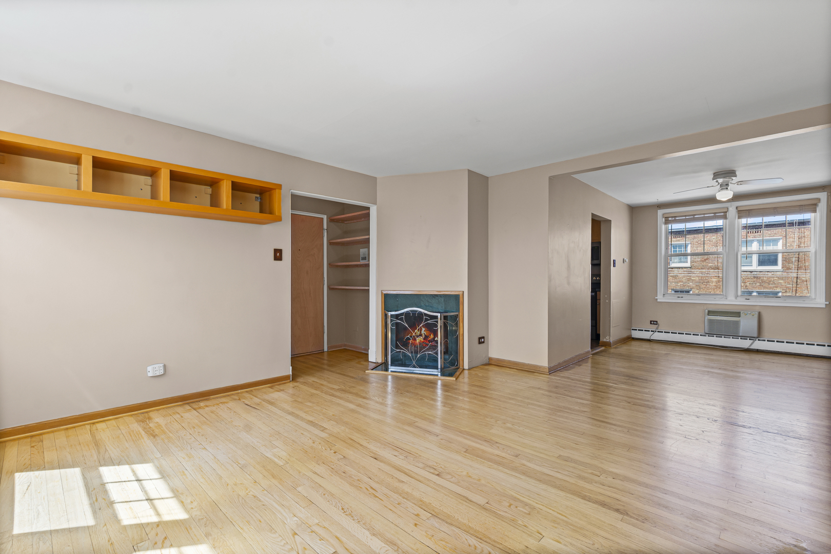 2434 West Farragut Avenue, Unit 3B Chicago, IL 60625 - Photo 10 of 20 an empty room with windows and fireplace