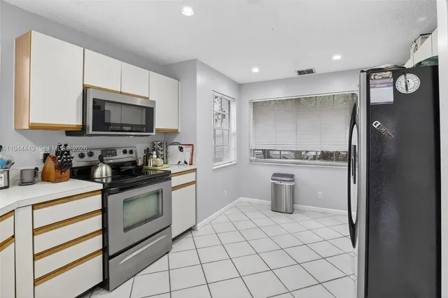 a kitchen with a stove a sink and a refrigerator