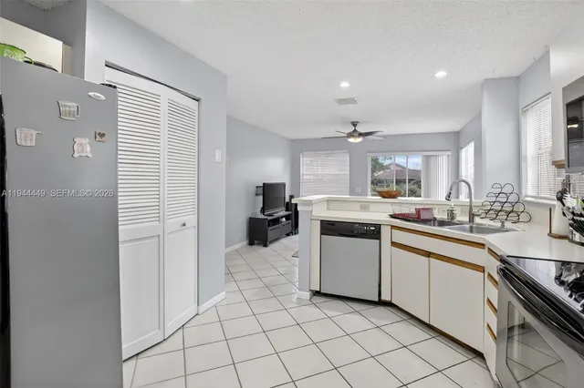 a kitchen with a sink cabinets and stainless steel appliances