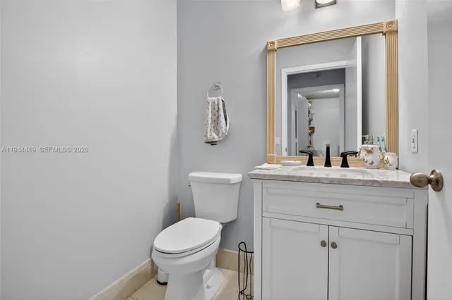 a bathroom with a toilet a sink and mirror