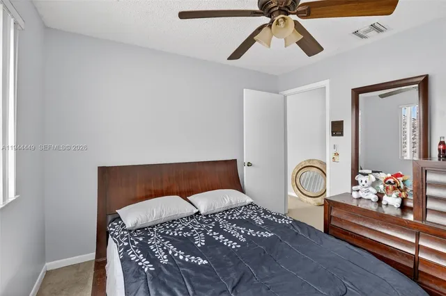 a bedroom with furniture and wooden floor