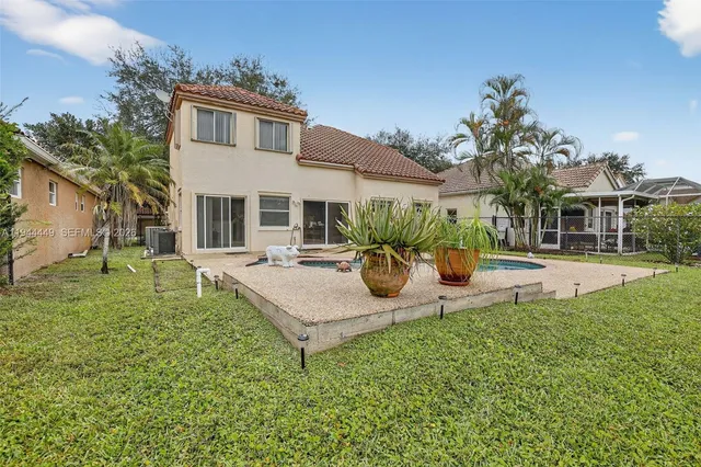 a view of a house with patio and a yard
