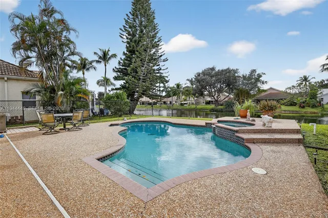 a view of swimming pool with outdoor seating and plants