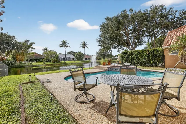 a view of a swimming pool with lounge chairs