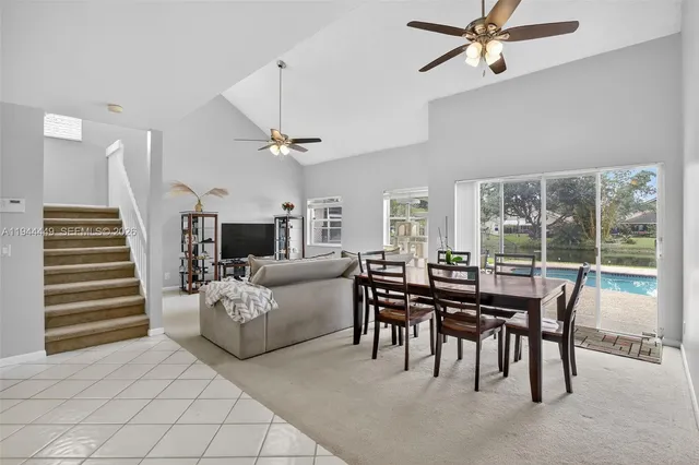 a view of a livingroom with furniture and a large window