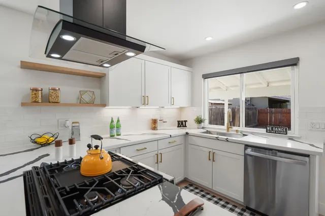 a kitchen with a sink appliances and cabinets