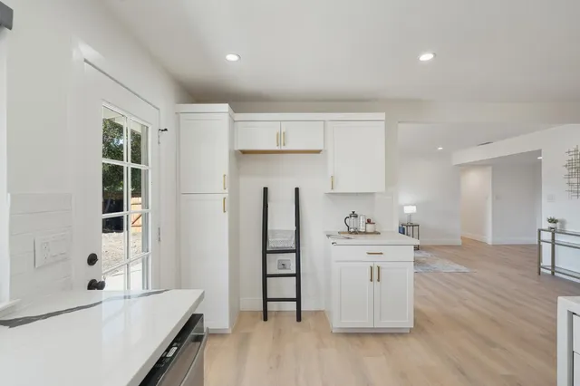 a kitchen with stainless steel appliances kitchen island granite countertop a refrigerator and a stove top oven