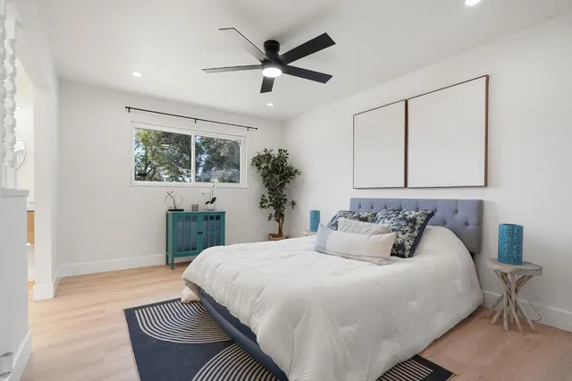 a bedroom with a bed and a chandelier