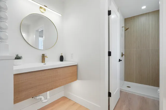 a bathroom with a tub sink and mirror
