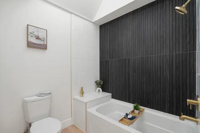 a bathroom with a sink a toilet and bathtub