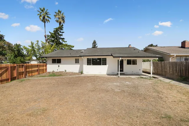 a front view of a house with a garden and yard