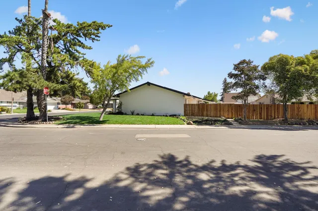 a house with a yard and a wooden fence