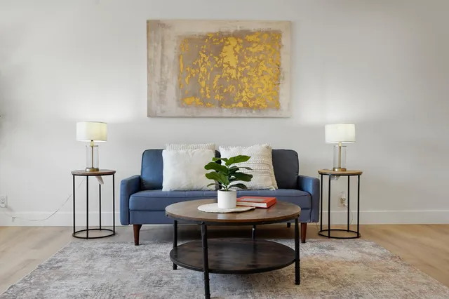 a dining room with furniture and a lamp