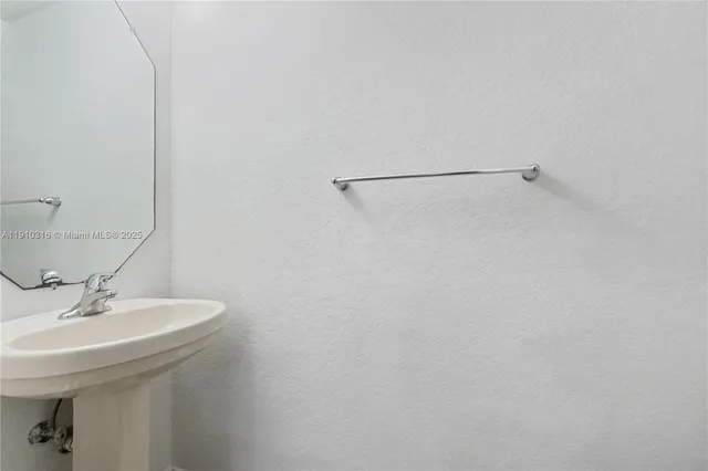 a bathroom with a sink and mirror