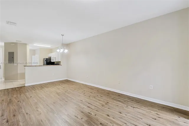 a view of a kitchen with a sink and wooden floor