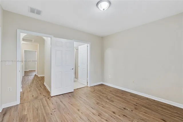 a view of a room with wooden floor